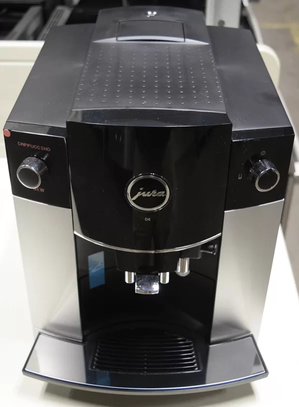 A close-up of a brand new Jura 15216 D6 Automatic Espresso Machine in black and platinum.