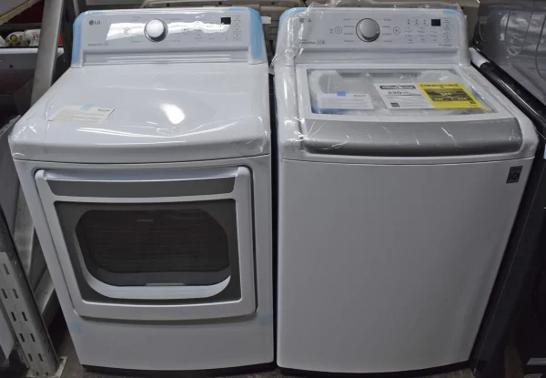 A close-up of two brand new LG DLE7150W and WT7150CW 27-inch Electric dryers and top-load washers.